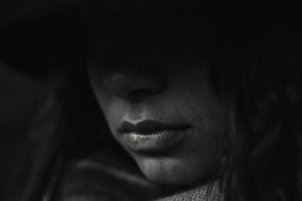 face in deep shadow
