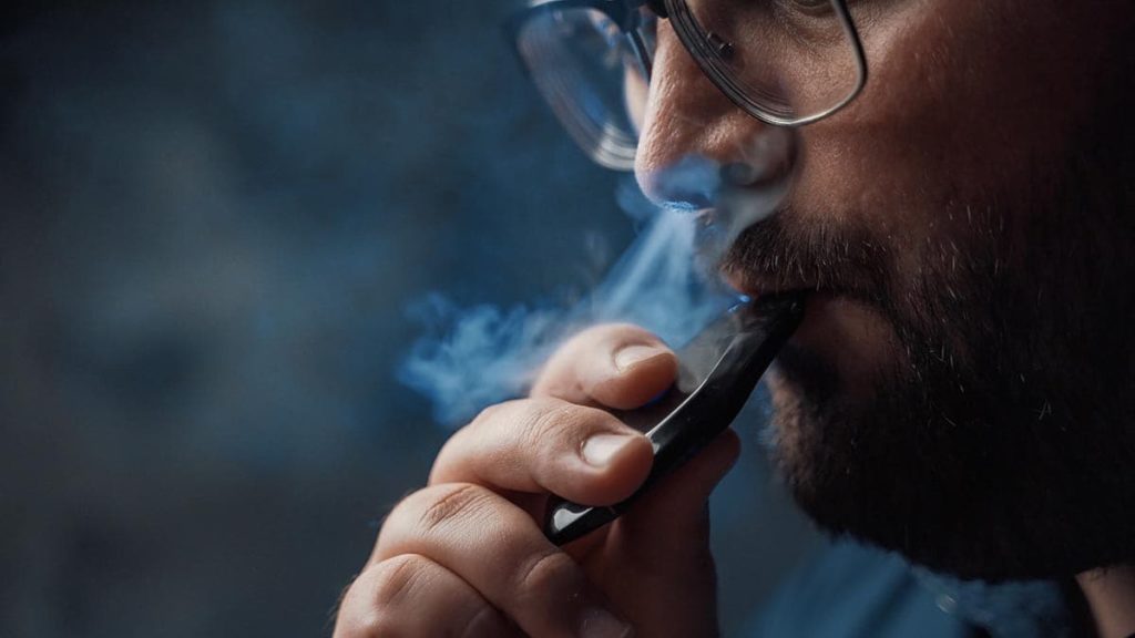 man hitting his dab pen mixing thc and vaping